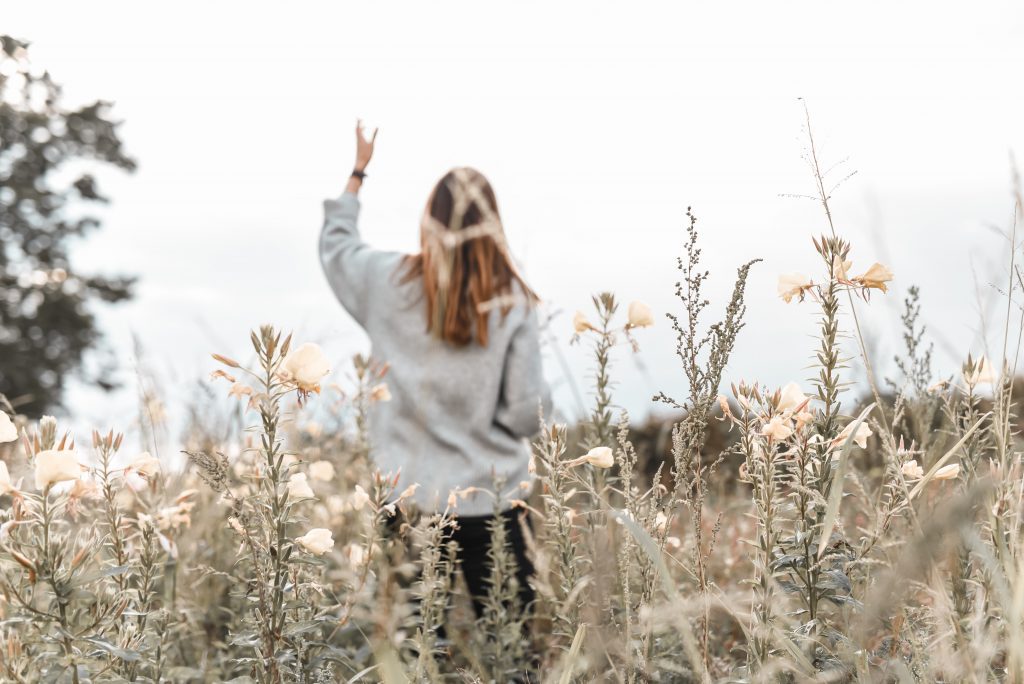 women in field worshiping
