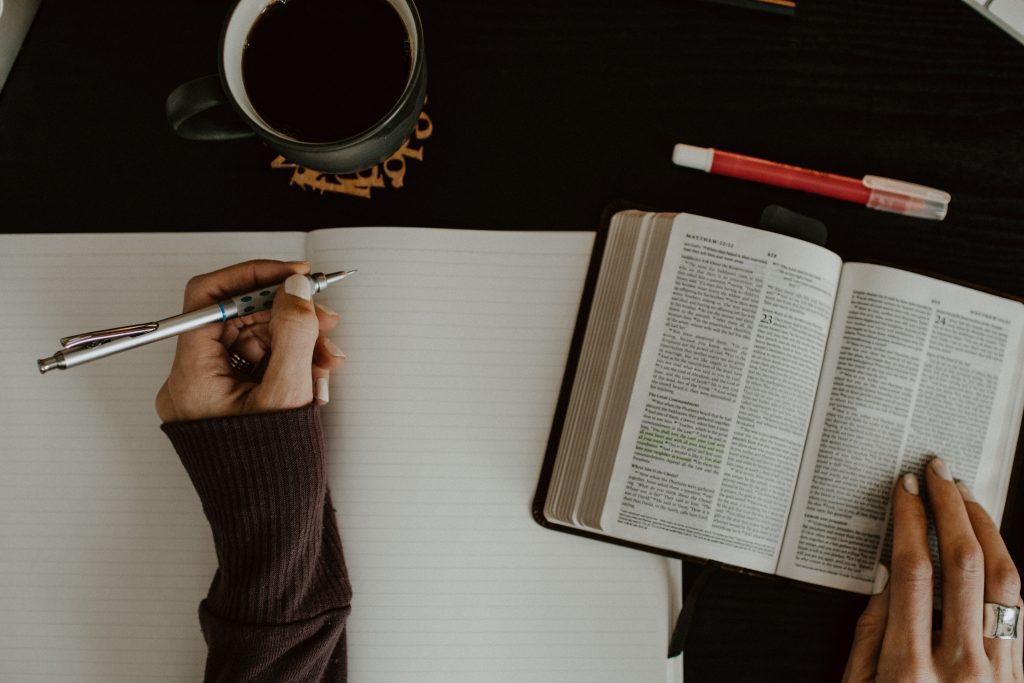 woman's
hands, prayer journal and Bible