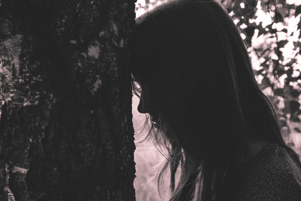  upset woman by tree trusting in God
black and white photo
