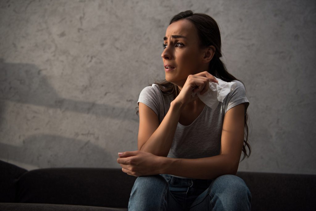 young women crying and needing help in the pain of grief
