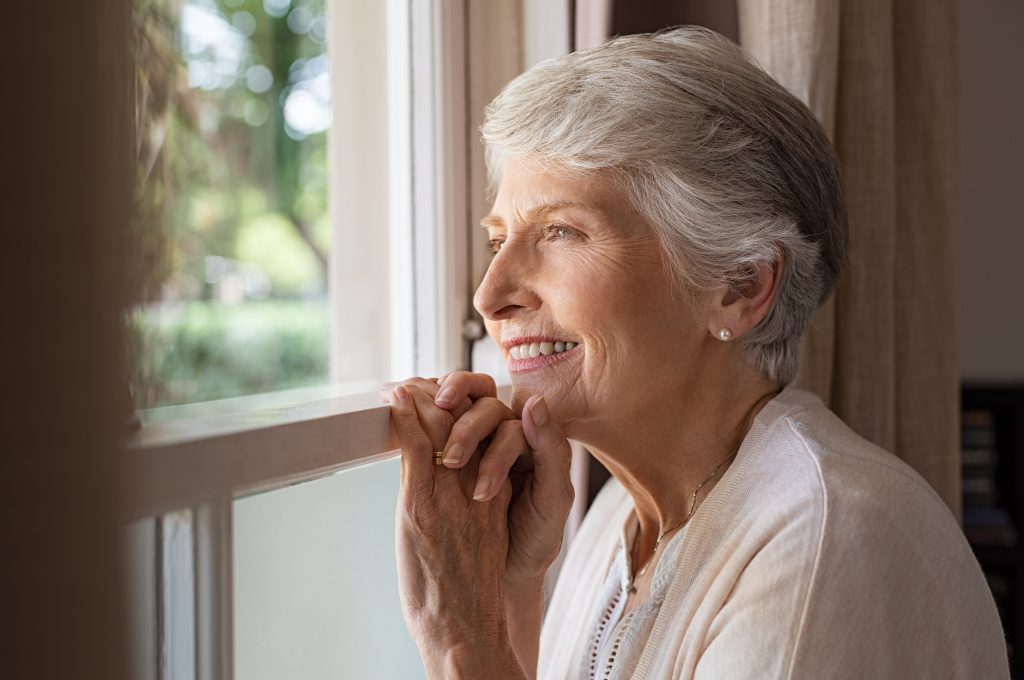 women looking out window smiling How to Encourage Yoursel in the Lord: Bible Verses of Hope