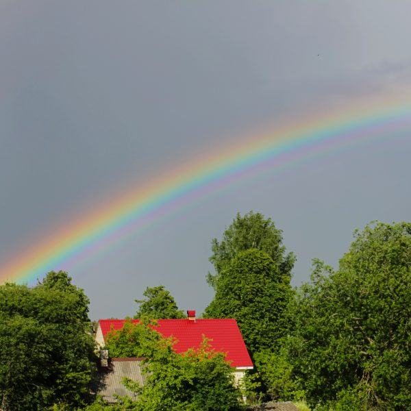 Rainbow over house and trees in sunshine. What are Promises of Hope in God?