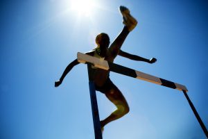 woman jumping hurdle. 6 Hurdles to Overcome in Submitting to God in Everything