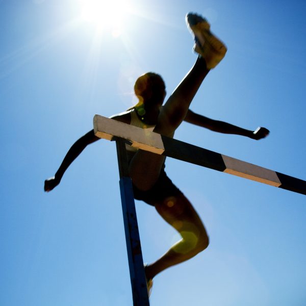 woman jumping hurdle. 6 Hurdles to Overcome in Submitting to God in Everything