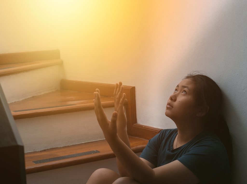 Woman praying and looking toward heaven. Strengthen Faith in God Through Trials