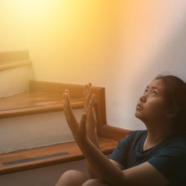 Woman praying and looking toward heaven. Strengthen Faith in God Through Trials