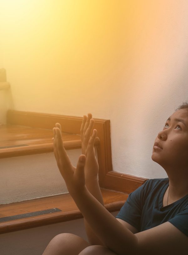 Woman praying and looking toward heaven. Strengthen Faith in God Through Trials