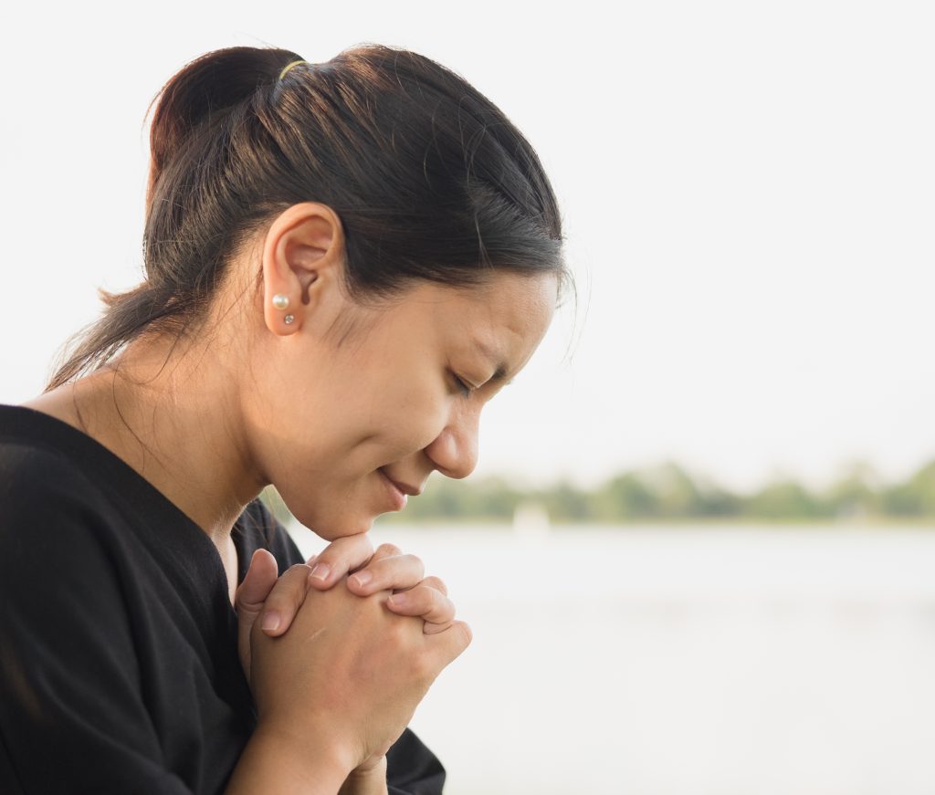 woman praying in front of water 6 Steps to Encourage Honor for God Daily