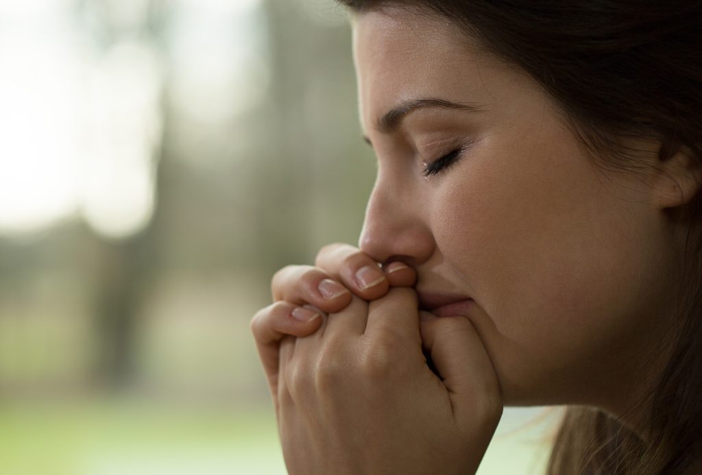 woman praying blurred background. A Consistent Prayer Life: A Beginner's Guide