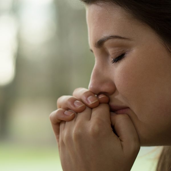 woman praying blurred background. A Consistent Prayer Life: A Beginner's Guide