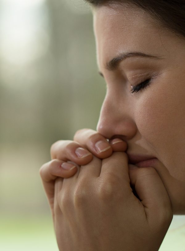 woman praying blurred background. A Consistent Prayer Life: A Beginner's Guide