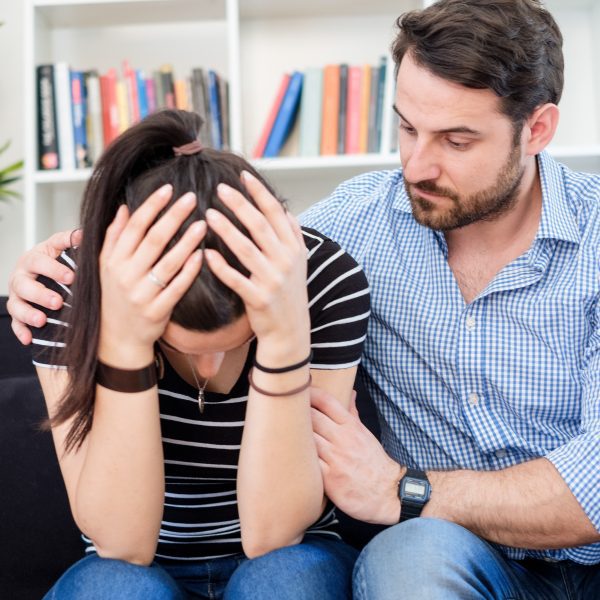 man comforting woman in living room. How to Pray When Life Feels Too Hard to Handle