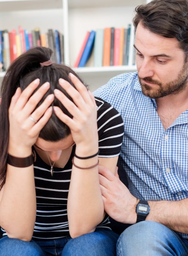 man comforting woman in living room. How to Pray When Life Feels Too Hard to Handle