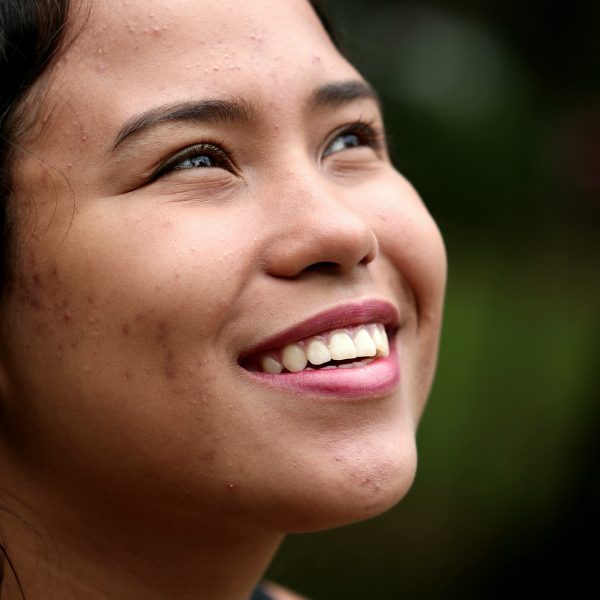 woman outside smiling hopefully at the sky. 5 Practical Ways to Strengthen Your Hope in God