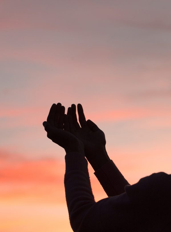 woman in evening shadow praising God. Why Praise is Your Most Powerful Weapon in Difficult Seasons